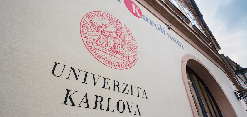 PRAGUE, CZECHIA - NOVEMBER 3, 2019: Charles university logo in front of their entrance. Charles university, or Univerzita Karolina, is the main academic center of Prague.Picture of a sign with the logo of Charles university in Prague, Czech Republic. Charles University, known also as Charles University in Prague or historically as the University of Prague, is the oldest and largest university in the Czech Republic. It is one of the oldest universities in Europe in continuous operation.